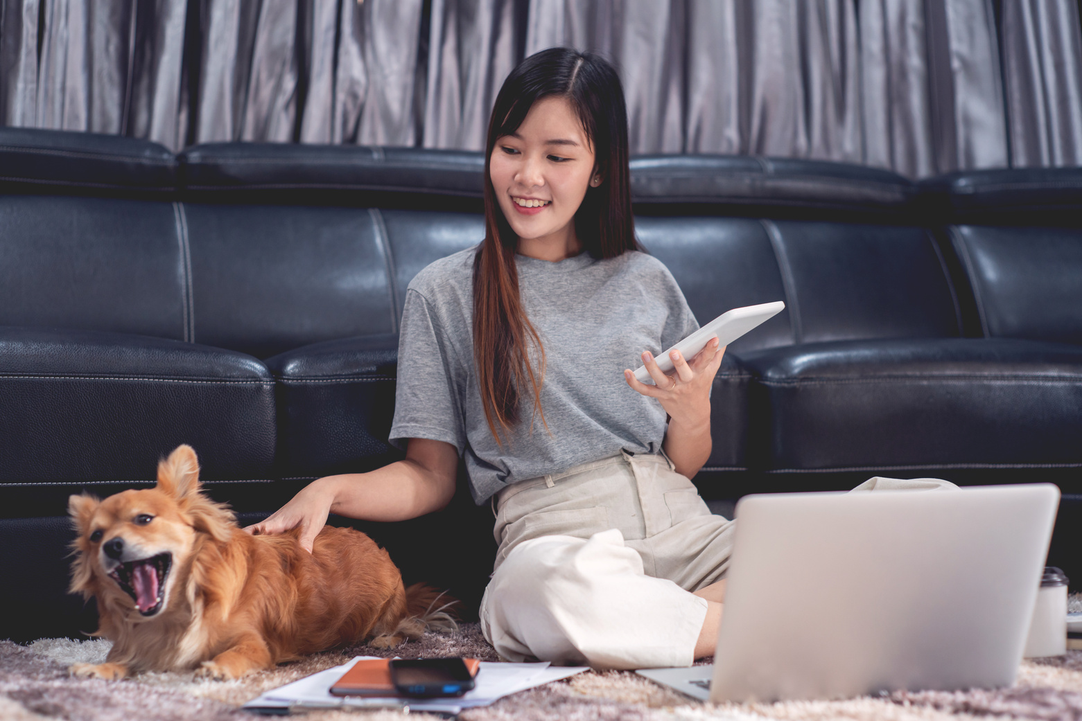 Woman Petting Her Dog While Working From Home